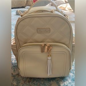 Itzy Ritzy NEW milk and honey mini diaper bag backpack with tassel.
